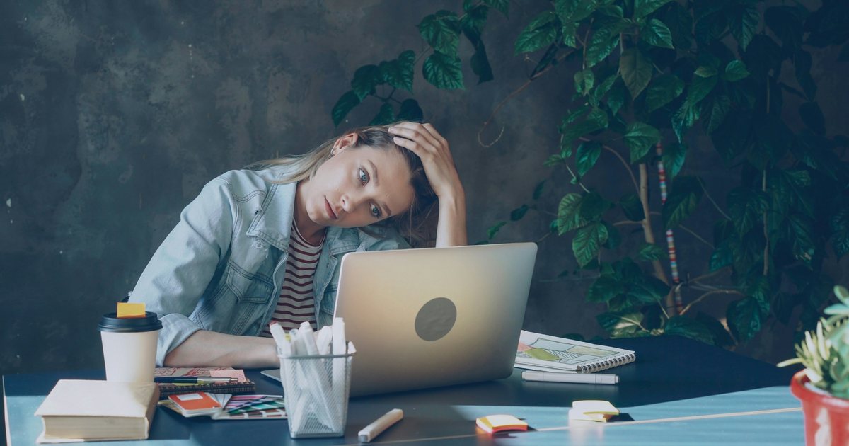 Stressed woman looking at her laptop
